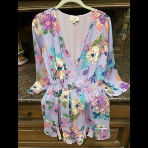 Purple floral romper size S- worn 1 time ! Bell sleeve and ruffle around shorts